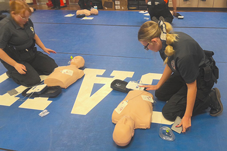 Two student learning cpr
