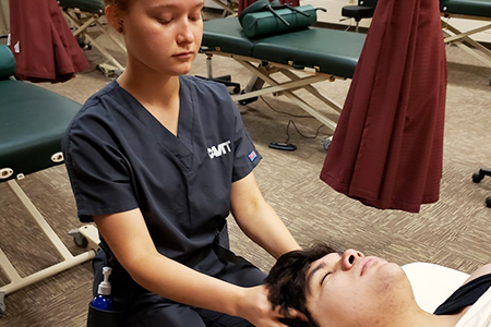 Massage therapy student practicing on a patient